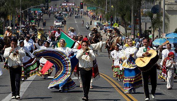A mariachi band and dancers lead a parade along Cesar Chavez Avenue in Los Angeles in celebration of Mexican Independence Day, which will be observed Sept. 16.