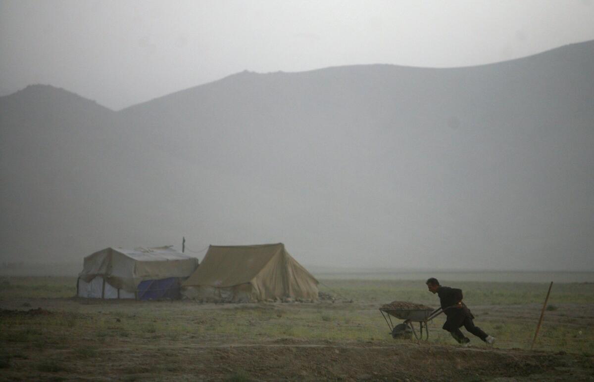 A displaced Afghan works in Barikab, Afghanistan.