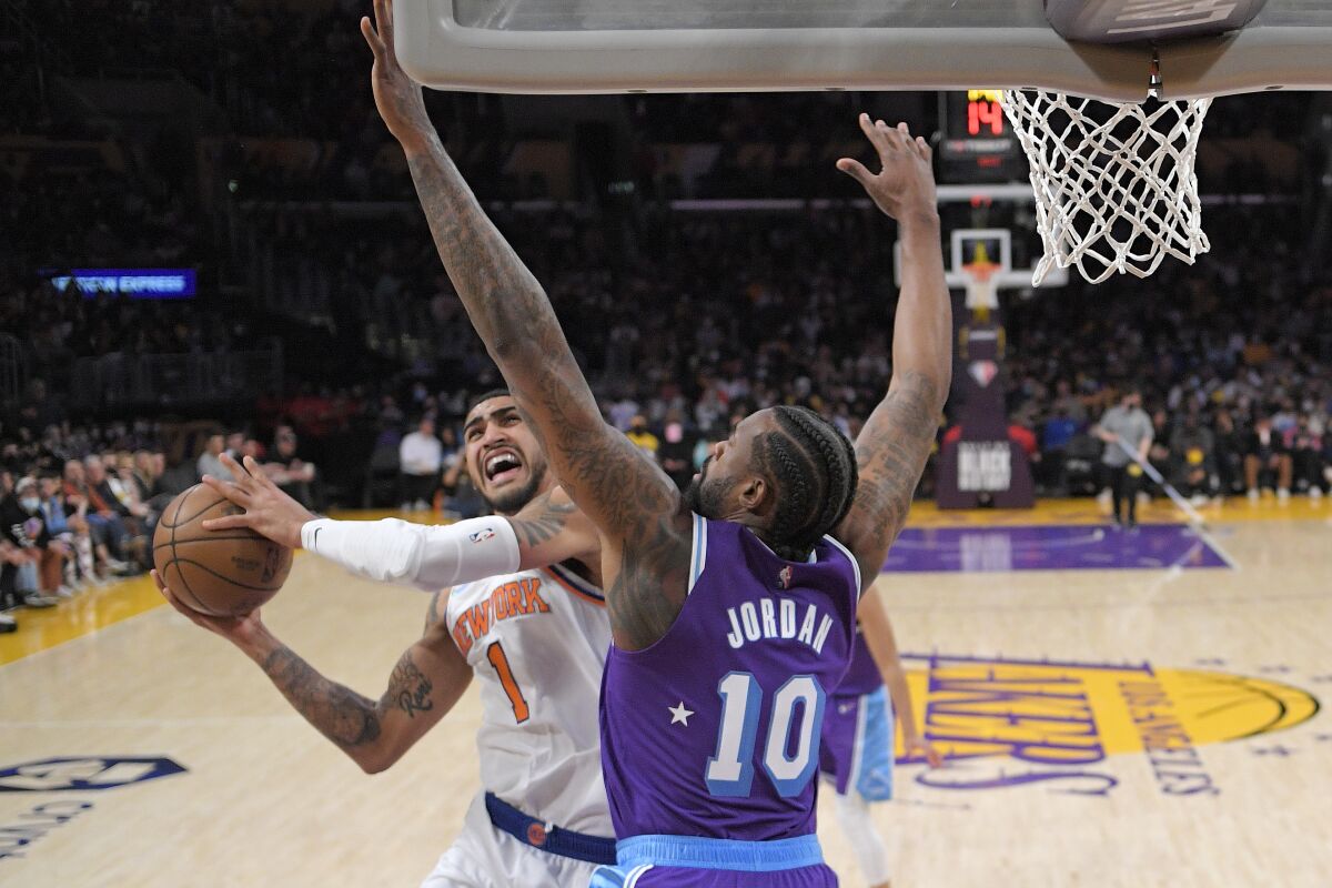 New York Knicks forward Obi Toppin, left, snoots as Los Angeles Lakers center DeAndre Jordan defends during the first half of an NBA basketball game Saturday, Feb. 5, 2022, in Los Angeles. (AP Photo/Mark J. Terrill)