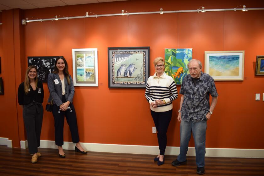 Birch Aquarium staff (left) with Vi residents at an art exhibit inspired by the Vi art group's visit to Birch.