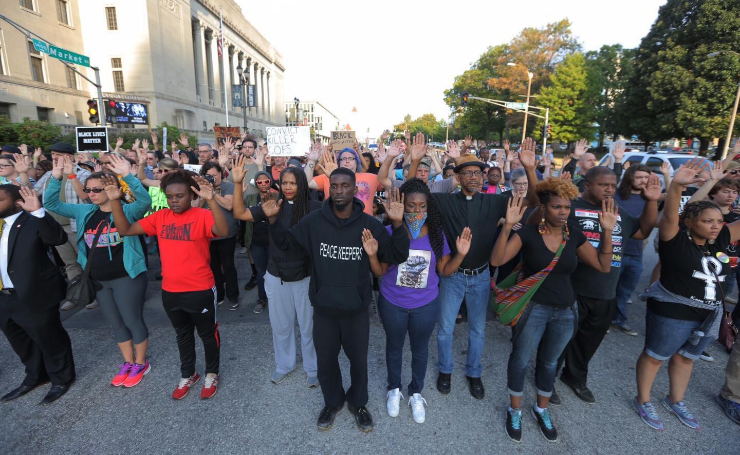 Protesters march in silence down Market Street in St. Louis on Sept. 18, 2017, in response to a not guilty verdict in the trial of former St. Louis police officer Jason Stockley. Stockley was acquitted on Friday in the 2011 killing of a black man following a high-speed chase.