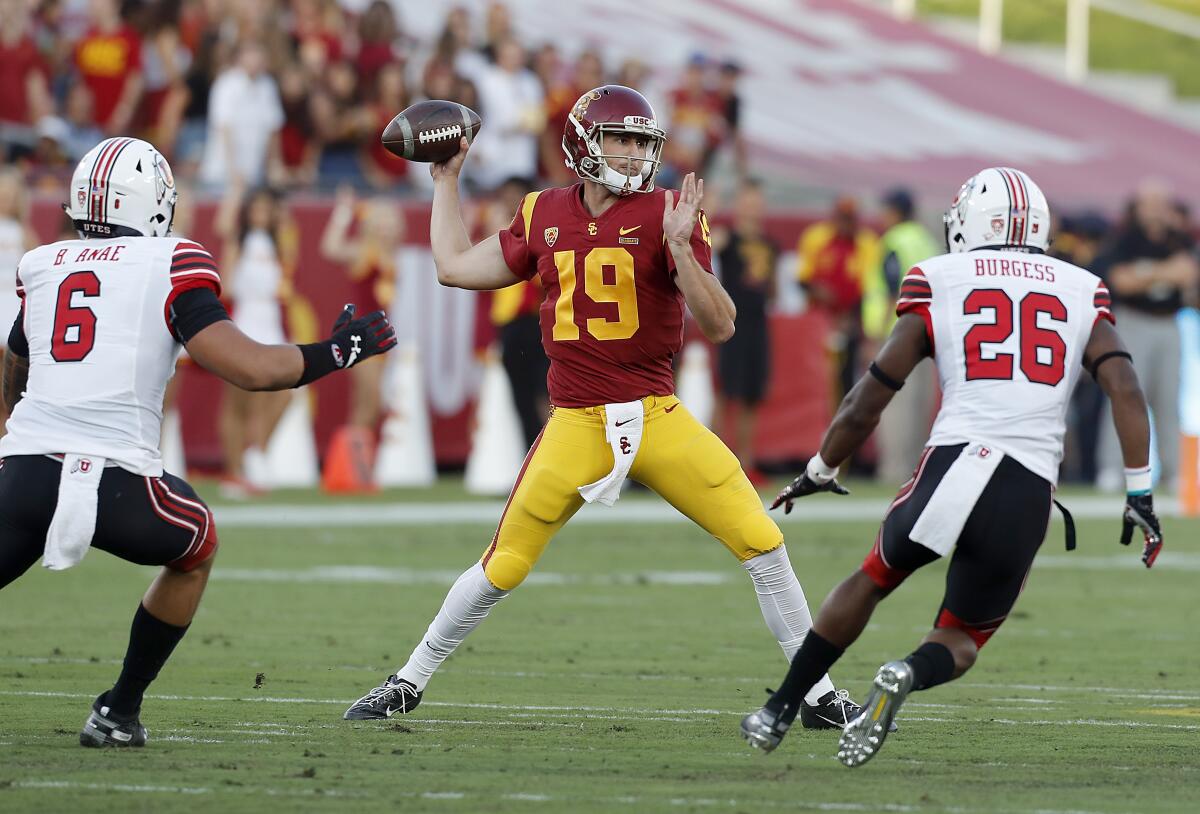USC quarterback Matt Fink throws downfield against Utah in the first quarter at the Coliseum on Friday.