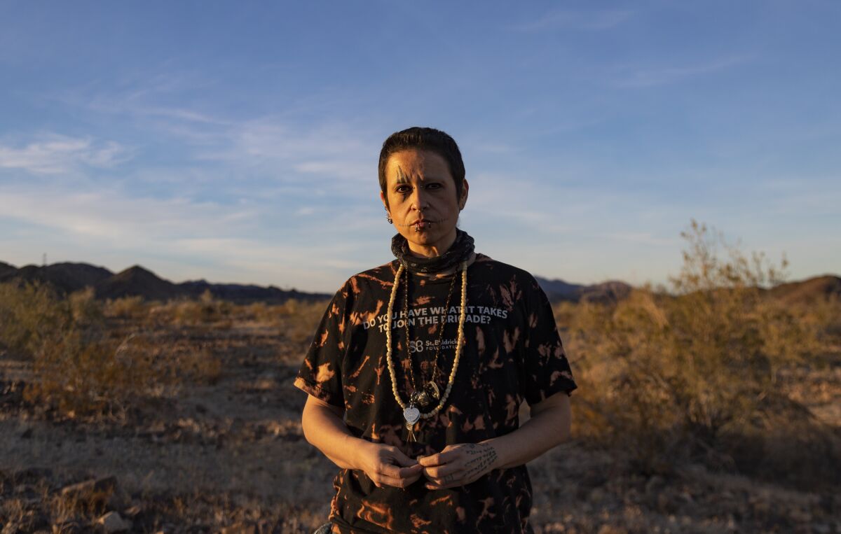 Lee King stands for a portrait in a desert landscape