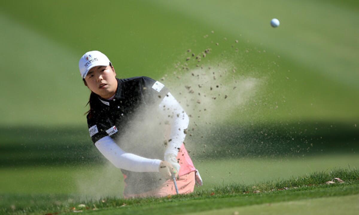 Shanshan Feng plays out of a bunker on the 11th hole during the first round of the Kraft Nabisco Championship at Mission Hills Country Club in Rancho Mirage on Thursday.