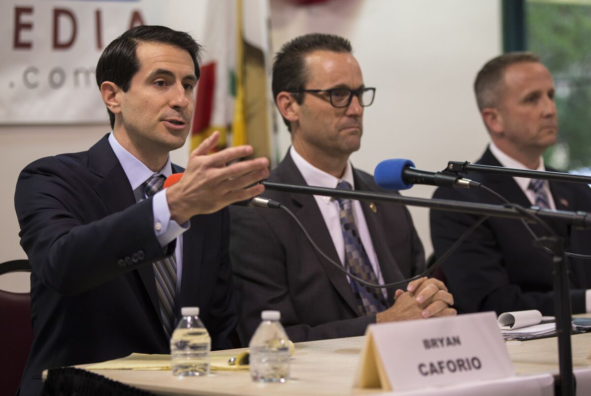 Bryan Caforio, left, candidate for the 25th Congressional District, gives his opening statement in a debate with Rep. Steve Knight (R-Lancaster), center, and LAPD Lt. Lou Vince, right, in May.
