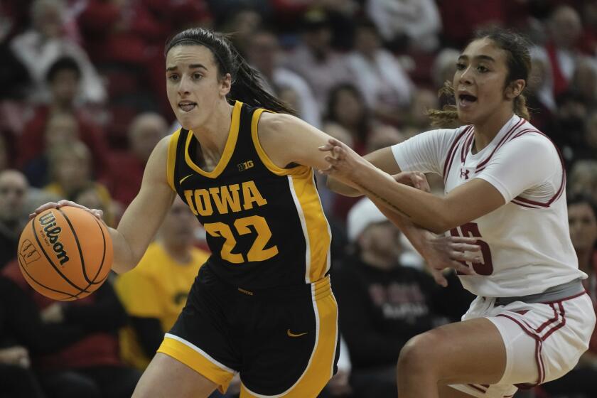 Iowa's Caitlin Clark drives past Wisconsin's Sania Copeland during the first half.