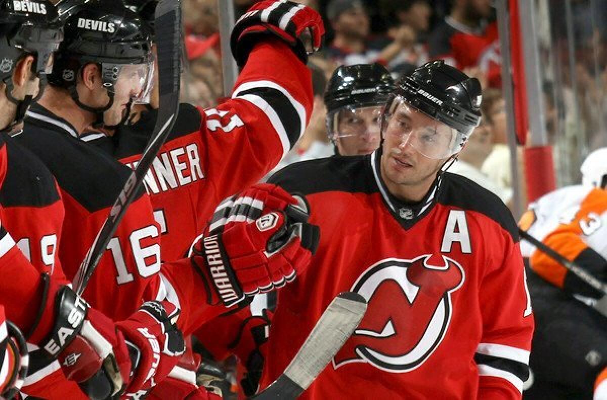 Ilya Kovalchuk is congratulated by Devils teammates after scoring a goal. He announced his retirement Thursday, walking away from $77 million and his NHL career.