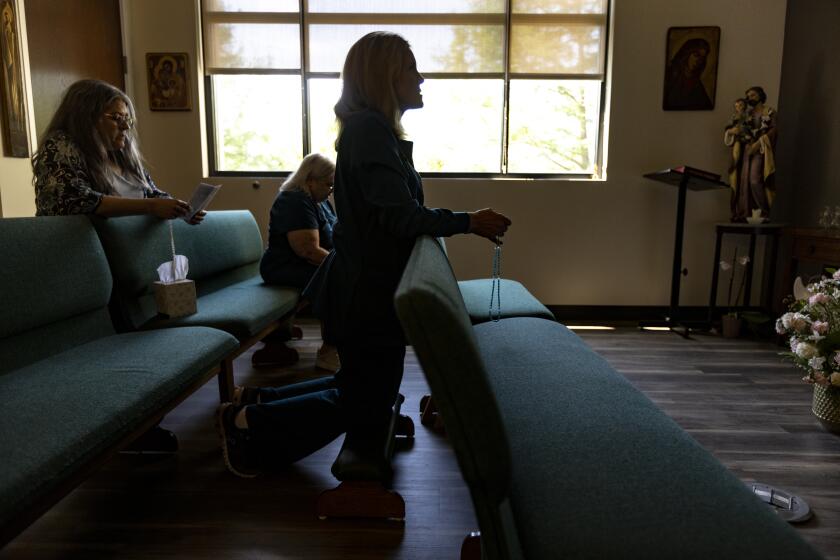 DALLAS, TX - MAY 18, 2022: Employees at Birth Choice pregnancy center pray before an altar inside the clinics chapel on May 18, 2022 in Dallas, Texas. They pray every afternoon "for the courts and for the protection of the unborn."(Gina Ferazzi / Los Angeles Times)