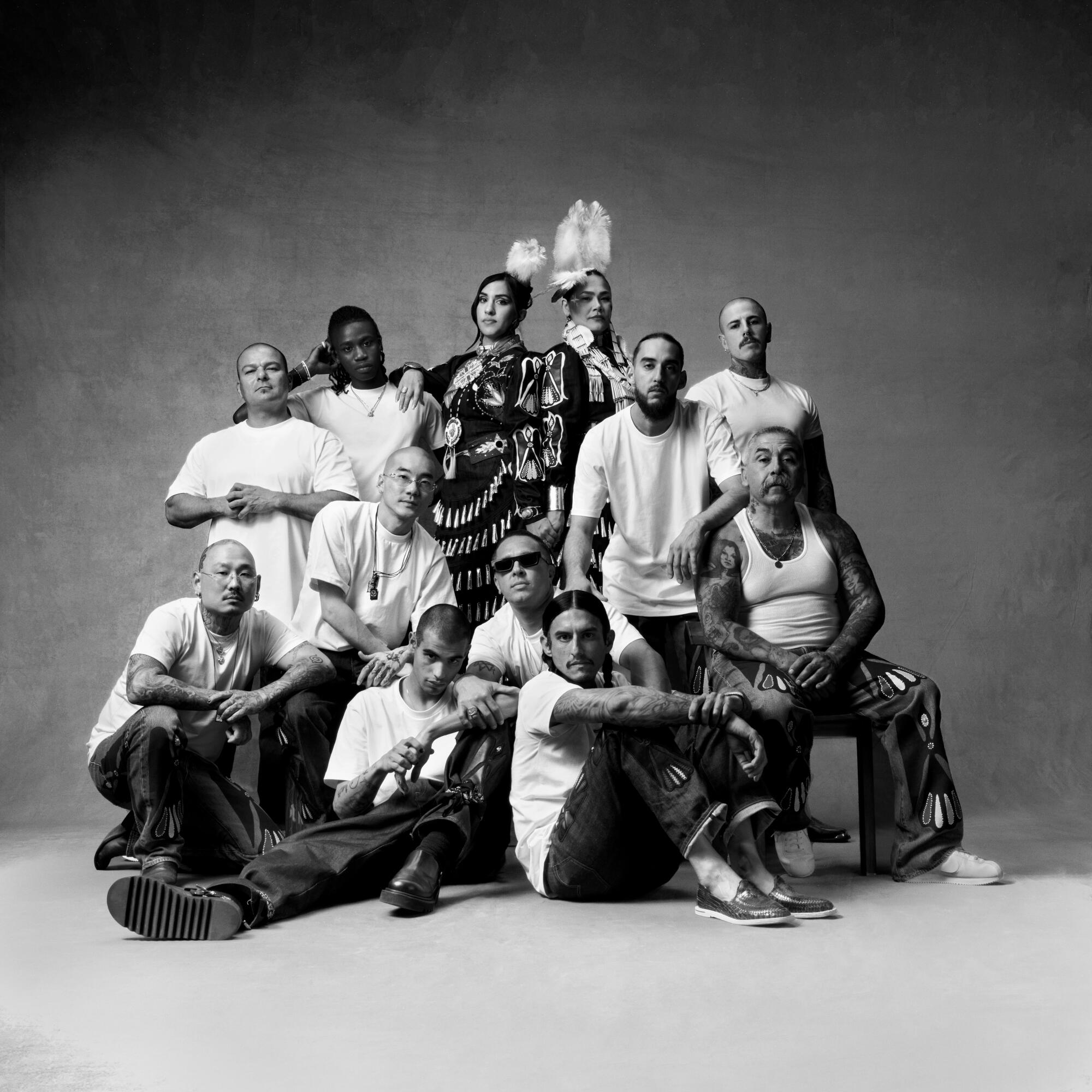 A group of people model the collection in studio.