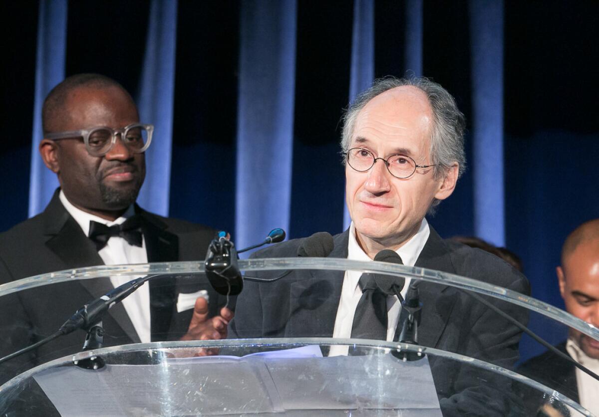 Charlie Hebdo Editor-in-Chief Gerard Biard accepts the Freedom of Expression Courage Award as Alain Mabanckou, left, looks on during the 2015 PEN Gala at the American Museum of Natural History in New York on May 5.