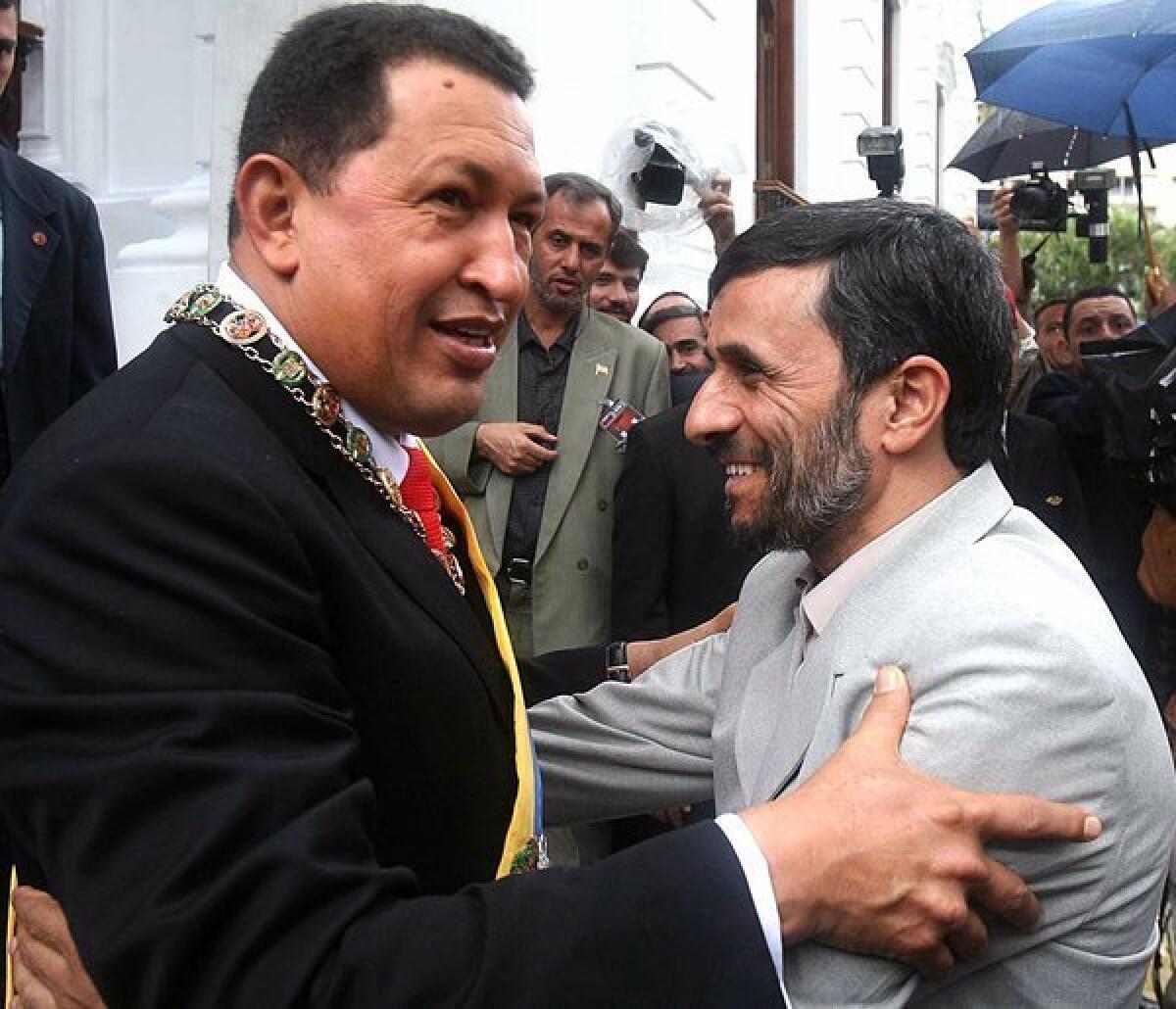 Venezuelan President Hugo Chavez, left, embraces Iranian President Mahmoud Ahmadinejad at the Miraflores Presidential Palace in Caracas.