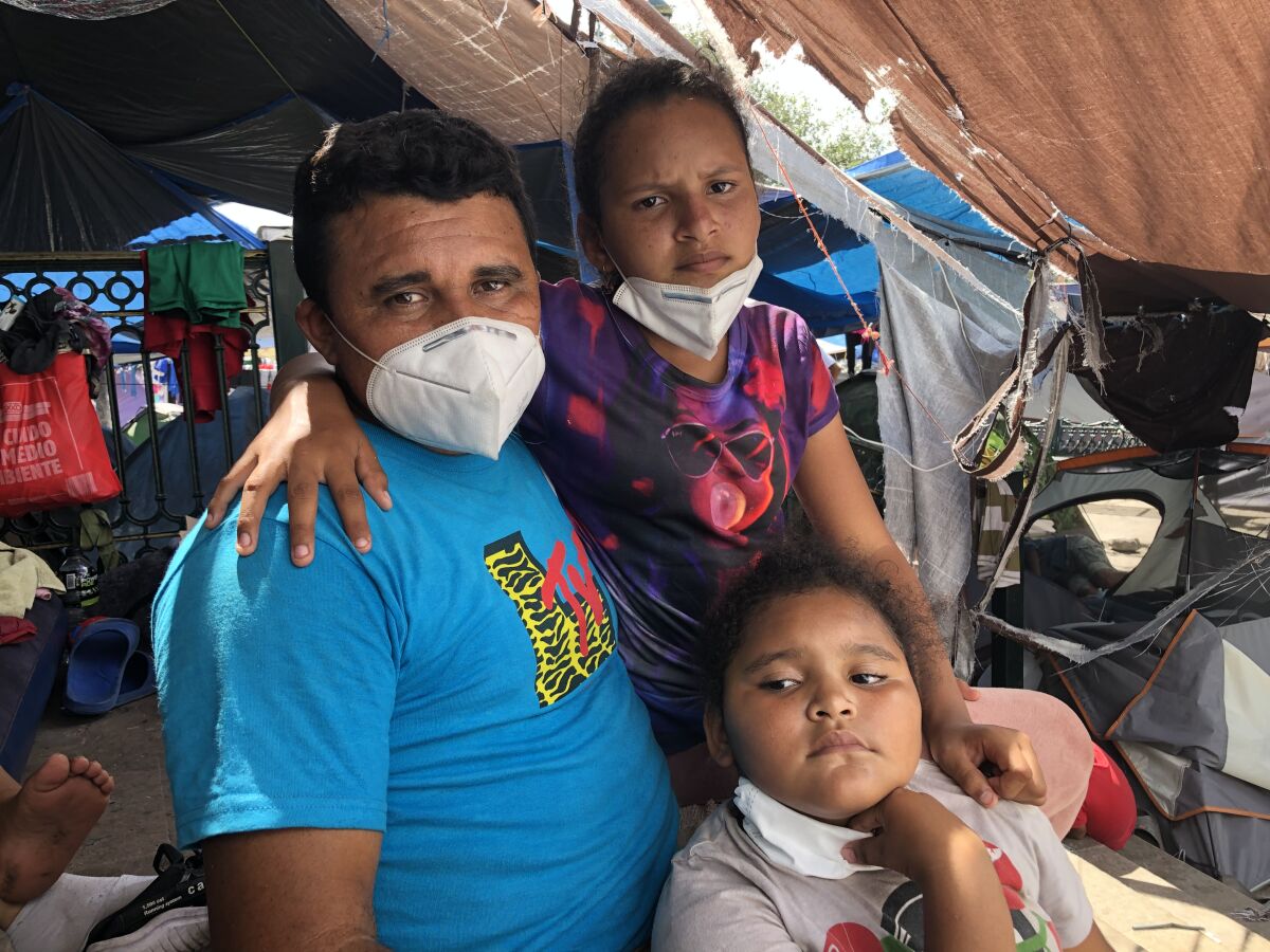 Abel Garcia, an asylum seeker from Honduras, with daughters Andrea, 11, and Ashley, 7, at the Reynosa camp 