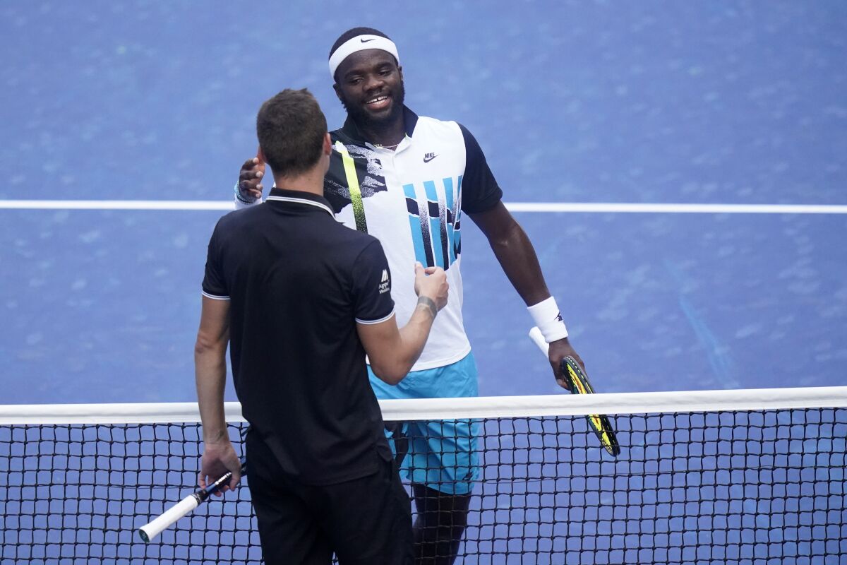 Frances Tiafoe, right, of the United States, reacts after winning a match against Marton Fucsovics, of Hungary, during the third round of the US Open tennis championships, Saturday, Sept. 5, 2020, in New York. (AP Photo/Frank Franklin II)