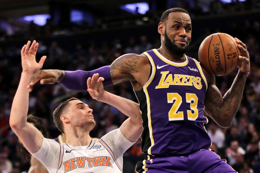 New York Knicks' Mario Hezonja, left, fouls Los Angeles Lakers' LeBron James during the first half of an NBA basketball game, Sunday, March 17, 2019, in New York. (AP Photo/Seth Wenig)