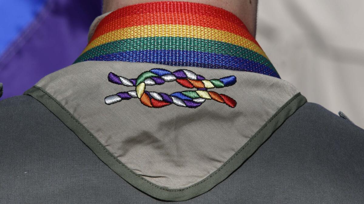 A Boy Scout wears a rainbow knot during Salt Lake City's annual gay pride parade in 2014.