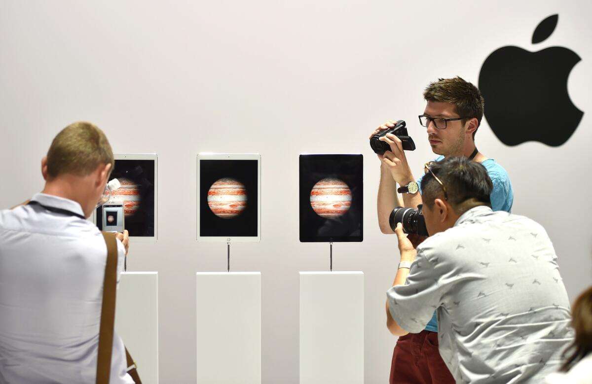 People take photos and videos of the iPad Pro during an Apple event in San Francisco on Wednesday.