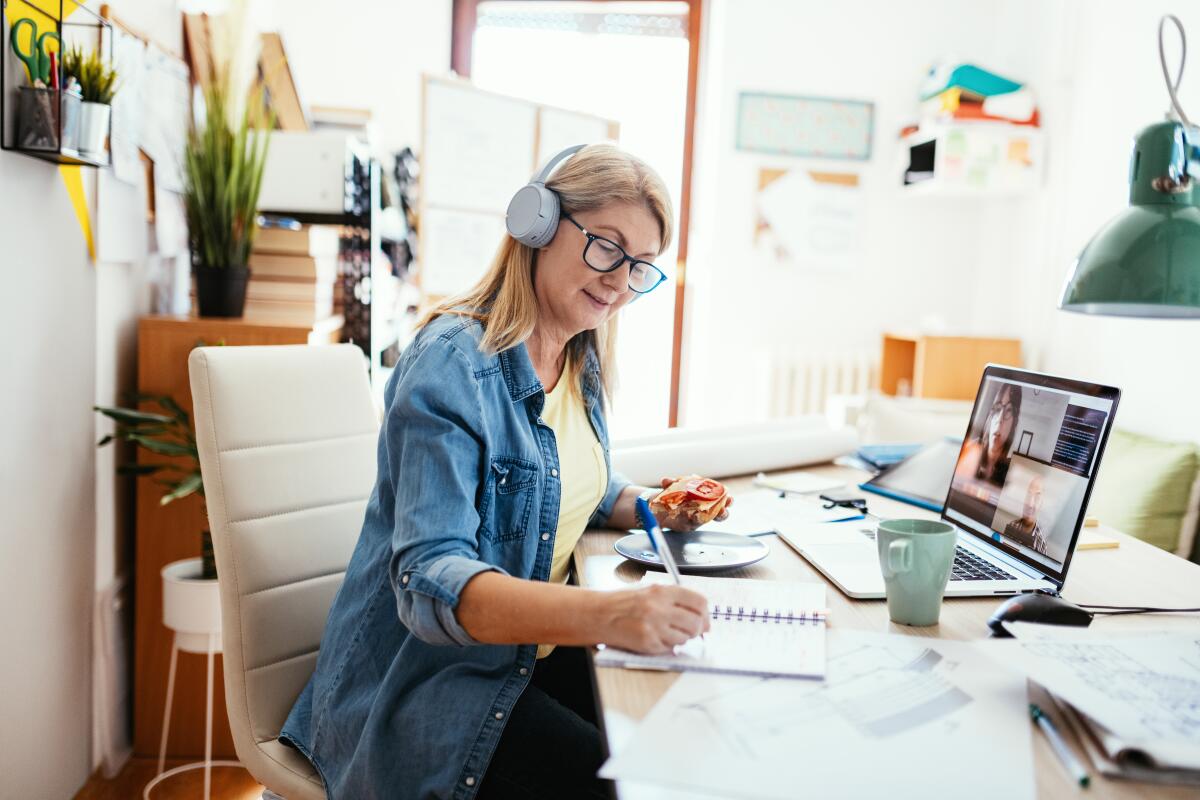 Woman works from home in front of computer.