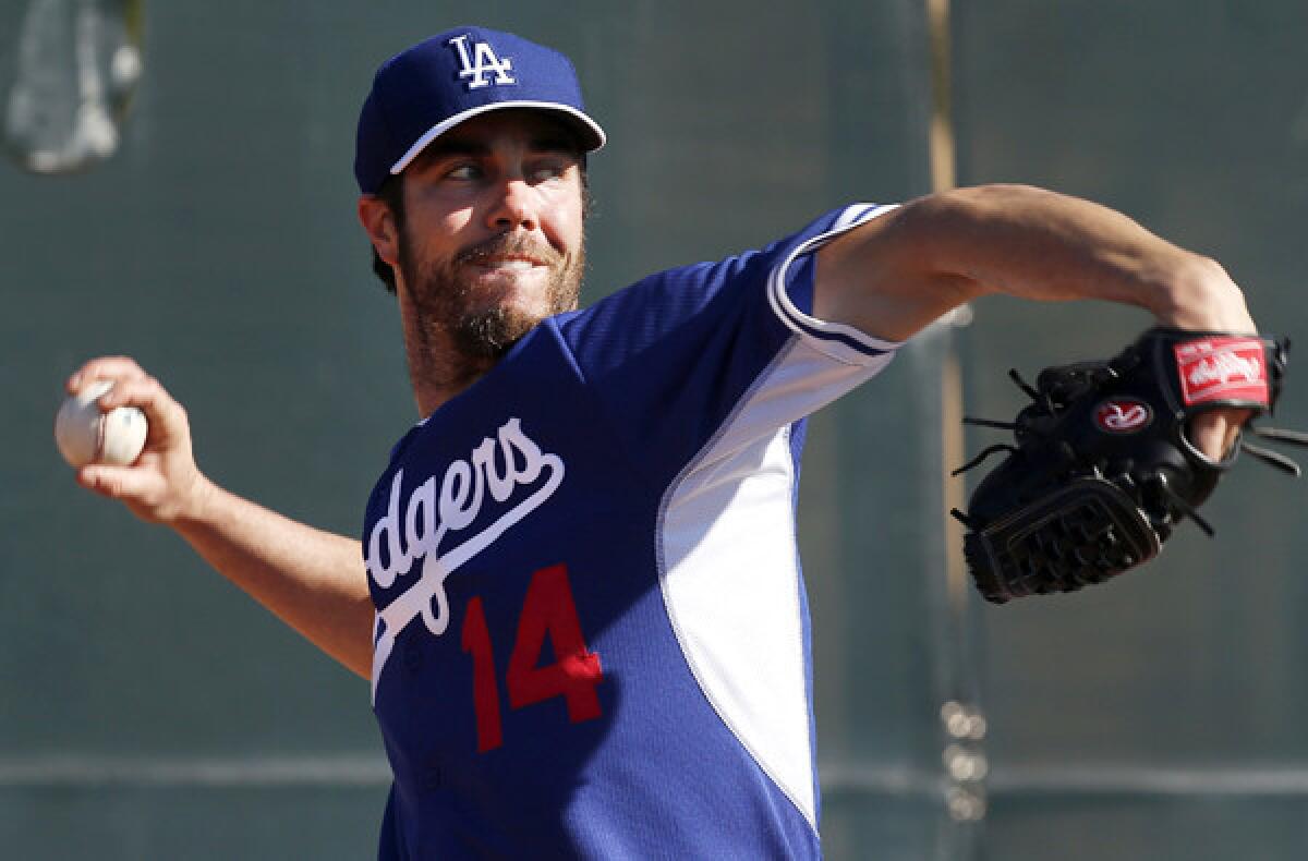 Dodgers starting pitcher Dan Haren loosens up during a spring training workout last month at Camelback Ranch.