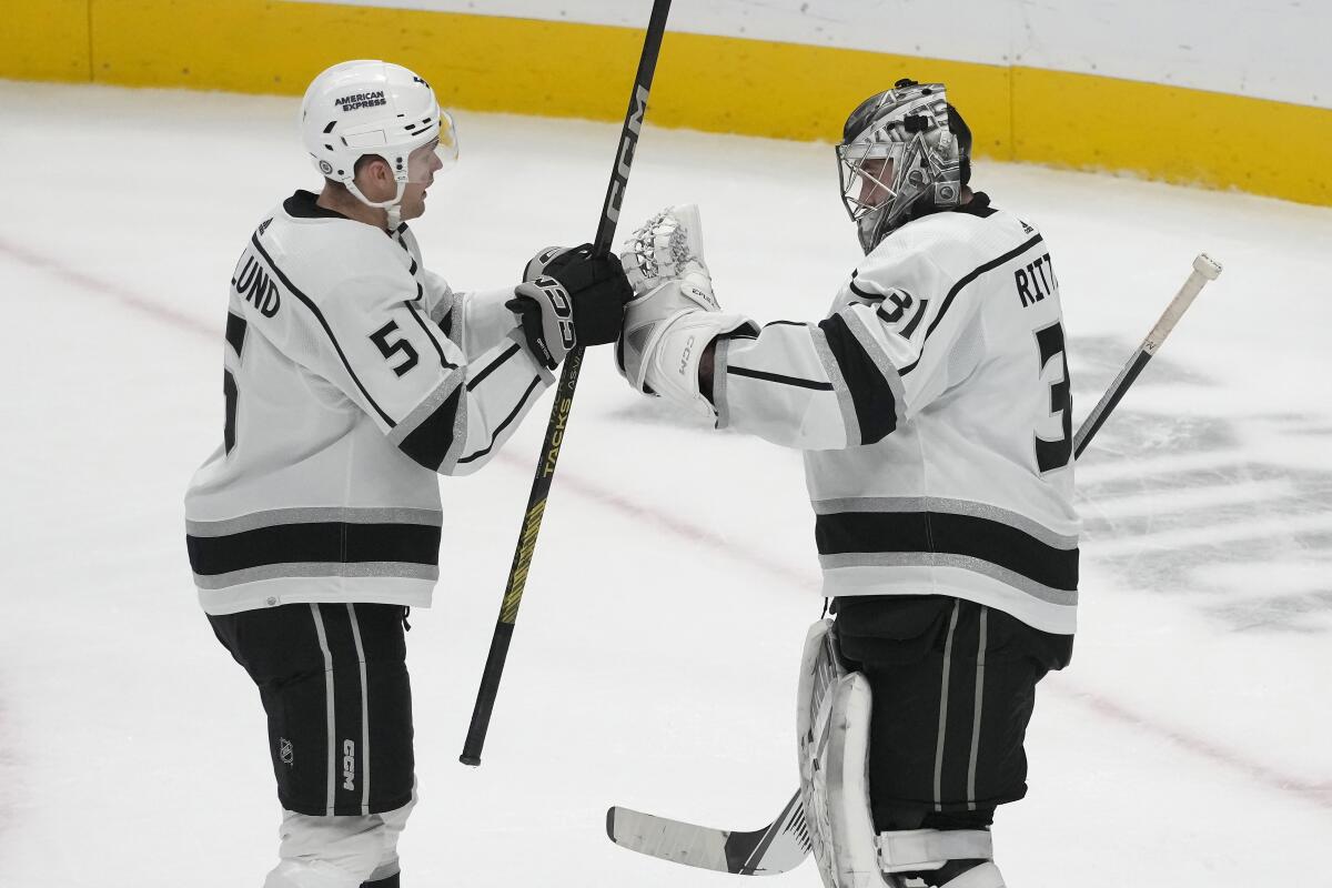Andreas Englund (5) and David Rittich celebrate after the Kings' victory.