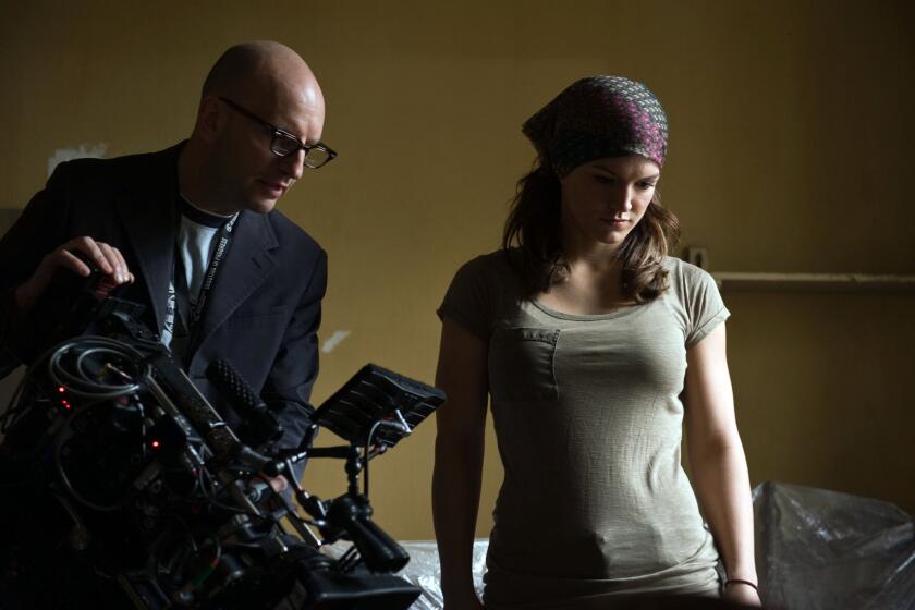 Gina Carano with director Steven Soderbergh on the set of the movie "Haywire."