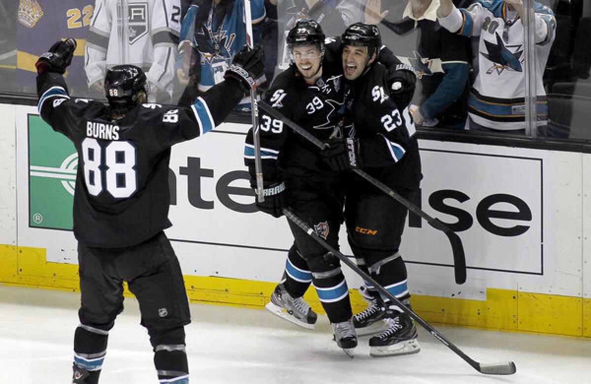 San Jose Sharks center Logan Couture (39) celebrates with Scott Gomez (23) and Brent Burns (88) after Couture scored the game-winning goal against the Kings.