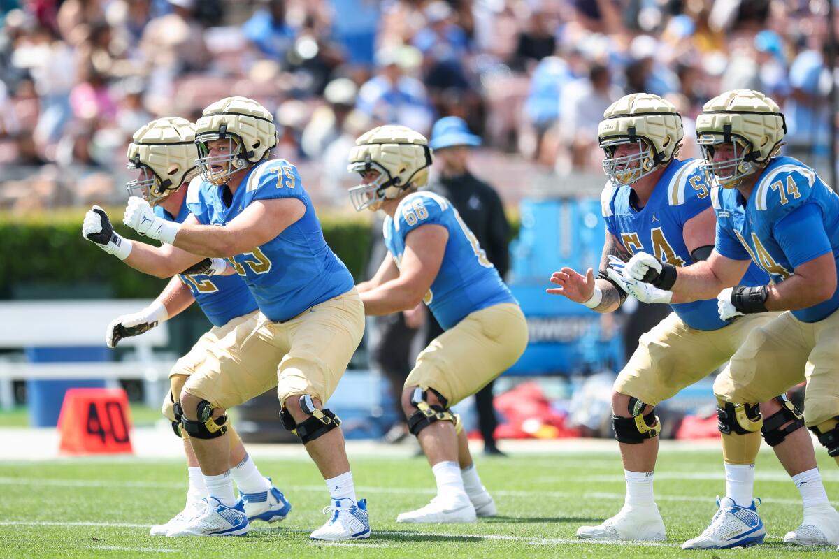 UCLA offensive linemen runs drills during the UCLA football spring showcase at the Rose Bowl on Saturday.