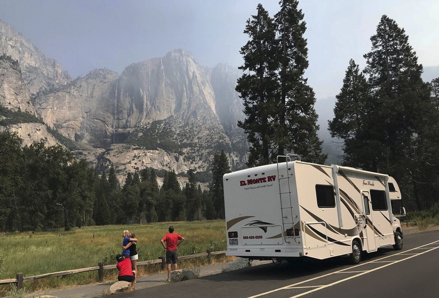 People stop to look at the smoke from nearby wildfires in Yosemite National Park.