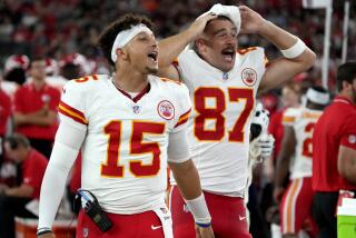 Kansas City Chiefs quarterback Patrick Mahomes (15) and tight end Travis Kelce (87) cheer from the sidelines