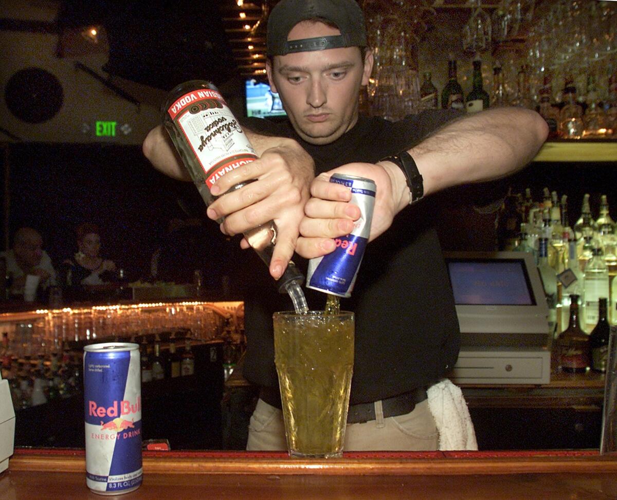 Bartender Tom Gordon pours a Red Bull and vodka mixed drink at Saddle Ranch restaurant in West Hollywood. A new study suggests drinking alcohol mixed with an energy drink may cause some to want to drink more alcohol.