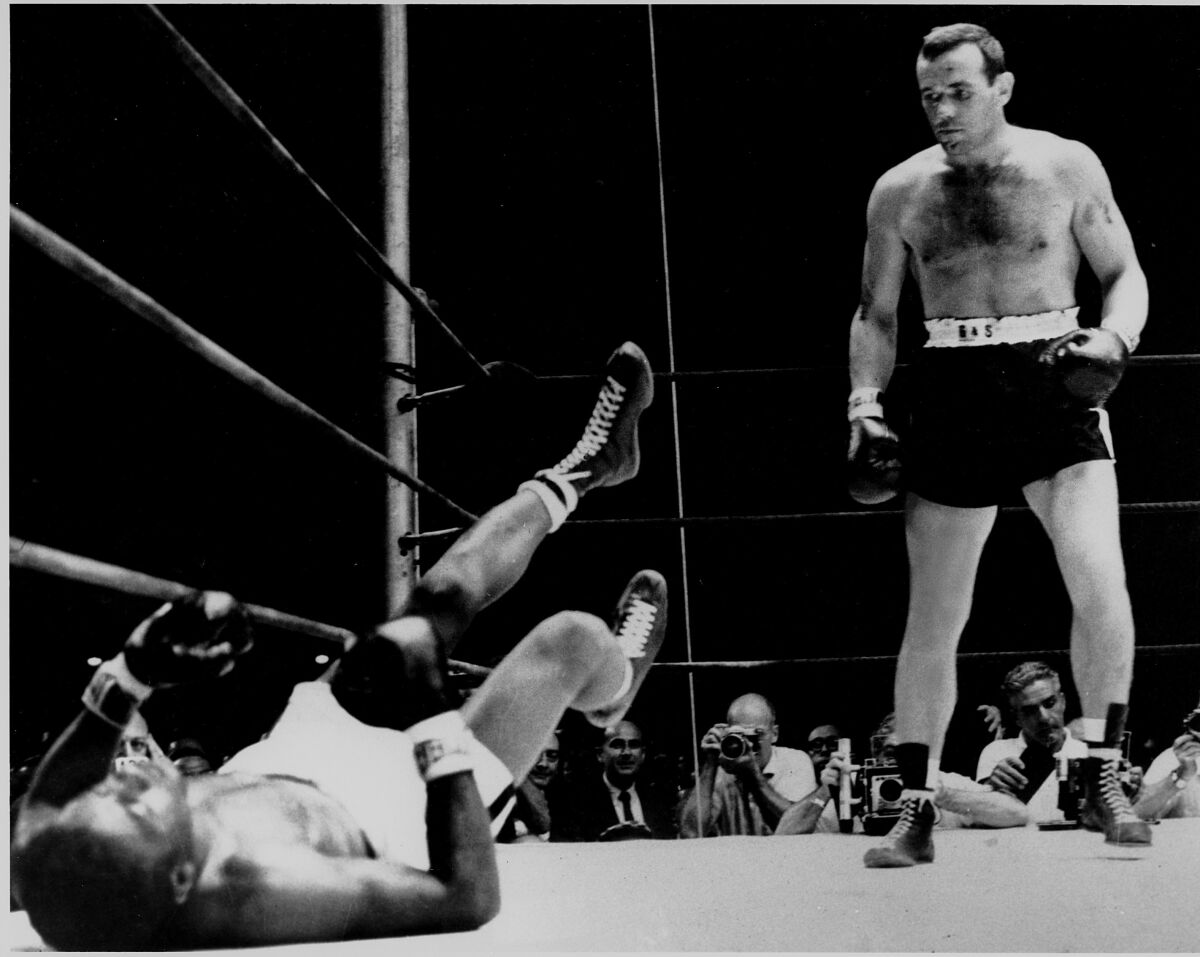 Floyd Patterson lies on the canvas after taking a knockout blow from Ingemar Johansson.
