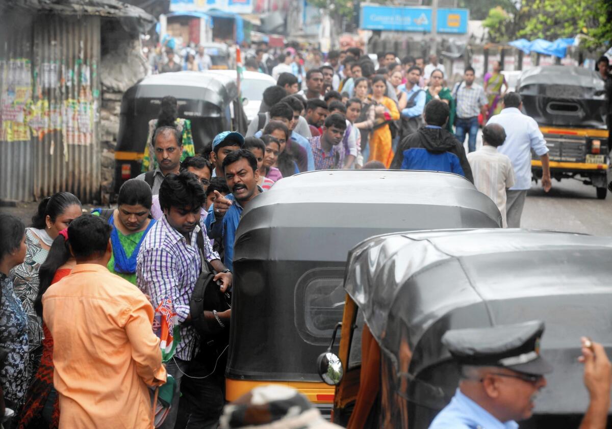 Uber this month launched in seven more Indian cities, taking its tally to 18 cities covered. Above, commuters face problems as auto-rickshaws go on a daylong strike in Mumbai last month.