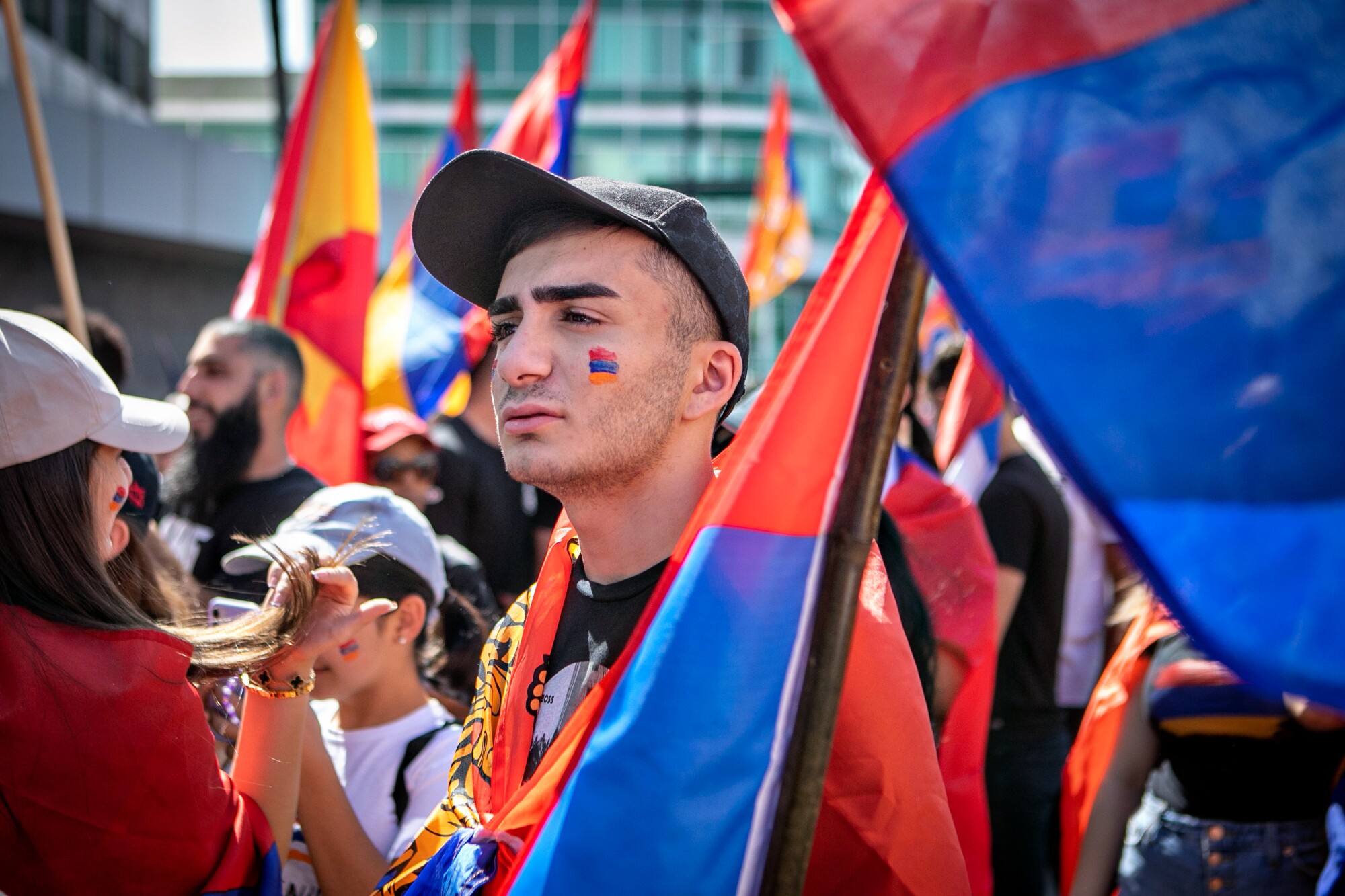 A man carries a flag with other protesters