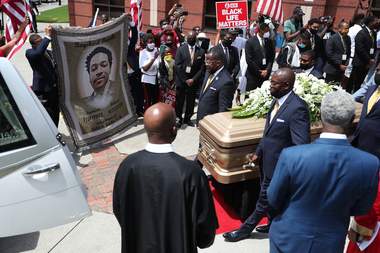 ATLANTA, GEORGIA - JUNE 23: The casket bearing the remains of Rayshard Brooks is carried to the hearse after his funeral service at the Ebenezer Baptist Church on June 23, 2020 in Atlanta, Georgia. Brooks was killed June 12 by an Atlanta police officer after a struggle during a field sobriety test in a Wendy's restaurant parking lot. (Photo by Joe Raedle/Getty Images)