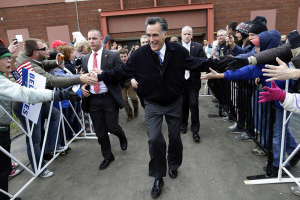 Mitt Romney arrives to speak to an overflow crowd of supporters as he campaigns at the Celina Fieldhouse in Celina, Ohio.