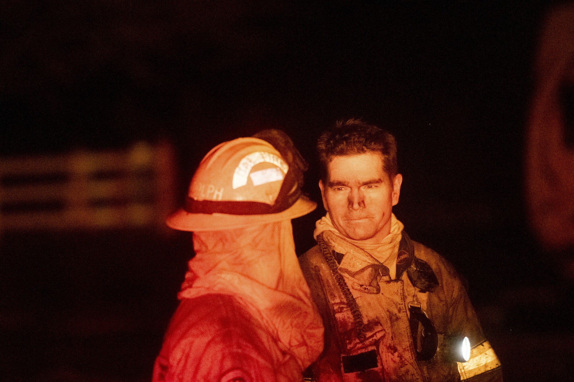 Firefighters speak to each other
