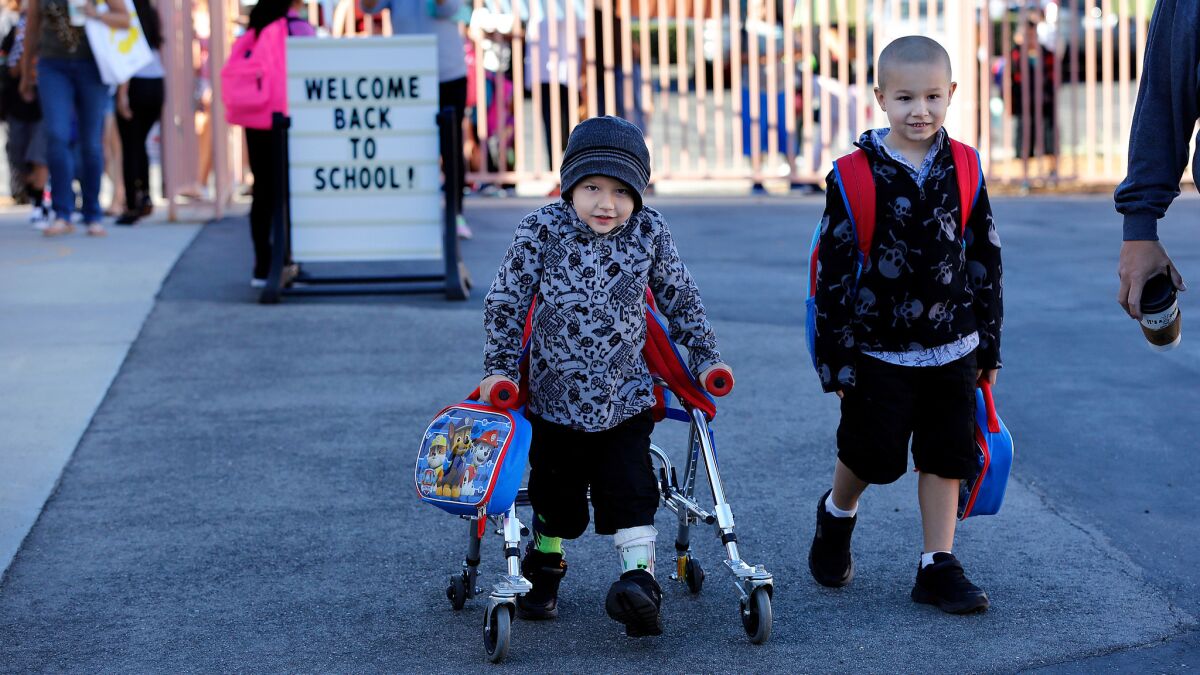 Lucian Olivera, left, and his brother Nikolas attend Peach Hill Academy Elementary School in Moorpark on the first day of school.