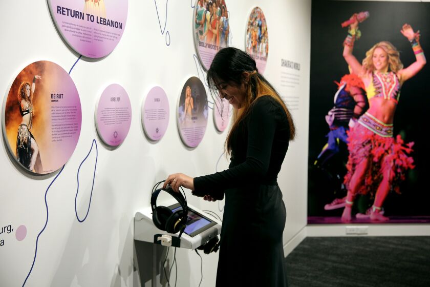 Stephanie Tamayo, 15 of New York, enjoys the audio at the Shakira: The GRAMMY Museum Experience at the GRAMMY Museum in Los Angeles on Friday, March 3, 2023.