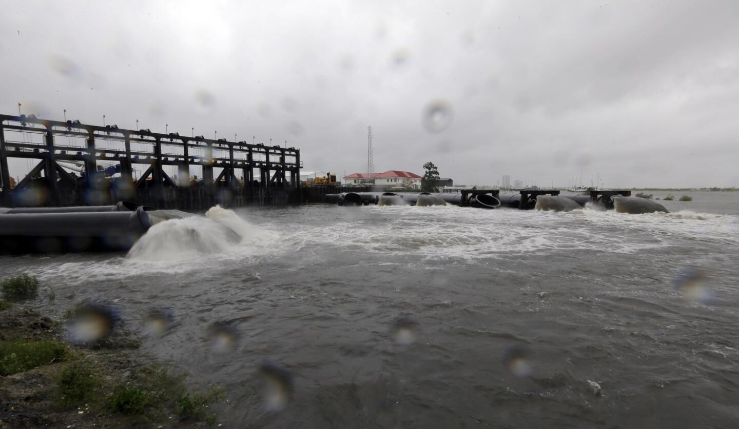 Water flows out of the new 17th Street Canal pumping station as Hurricane Isaac hits in New Orleans.