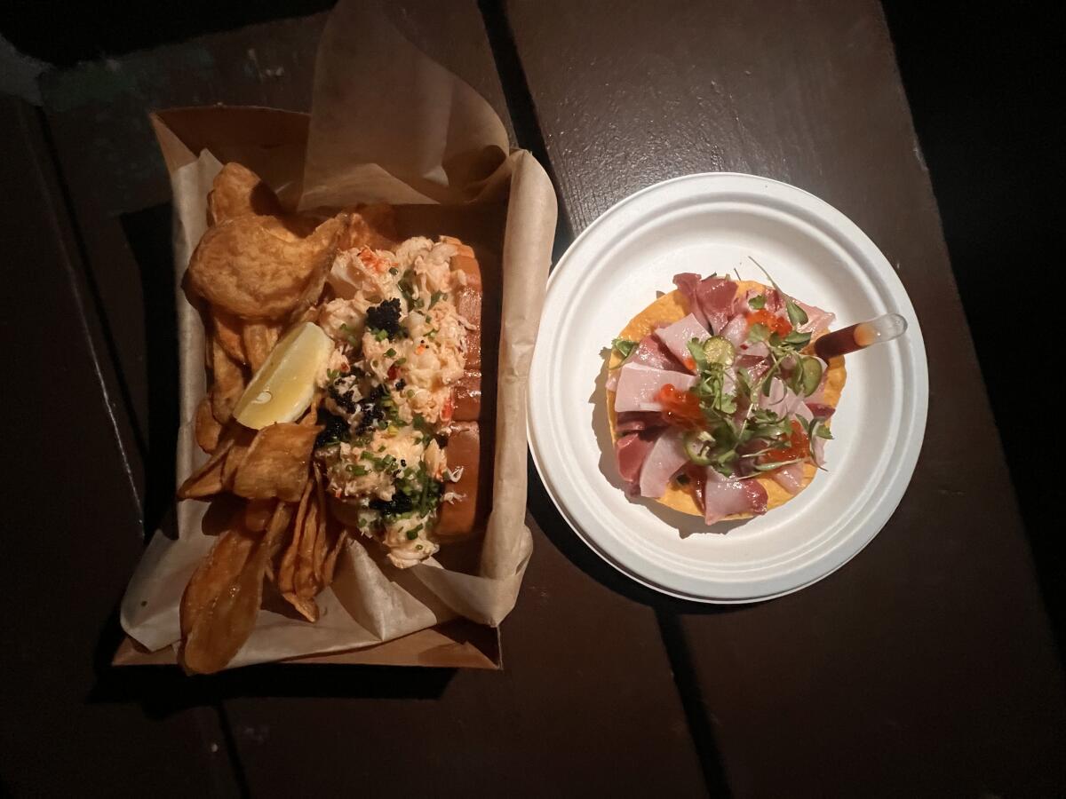 A loaded lobster roll with tobiko and a kanpachi tostada
