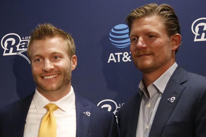 THOUSAND OAKS, CA - JANUARY 13, 2017 - Sean McVay, center, the youngest coach in NFL history poses with Rams COO Kevin Demoff, left, and Les Snead, right, General Manager holding the Rams jersey after being introduced as the new Rams head coach at their headquarters in Thousand Oaks on January 13, 2017. (Al Seib / Los Angeles Times)
