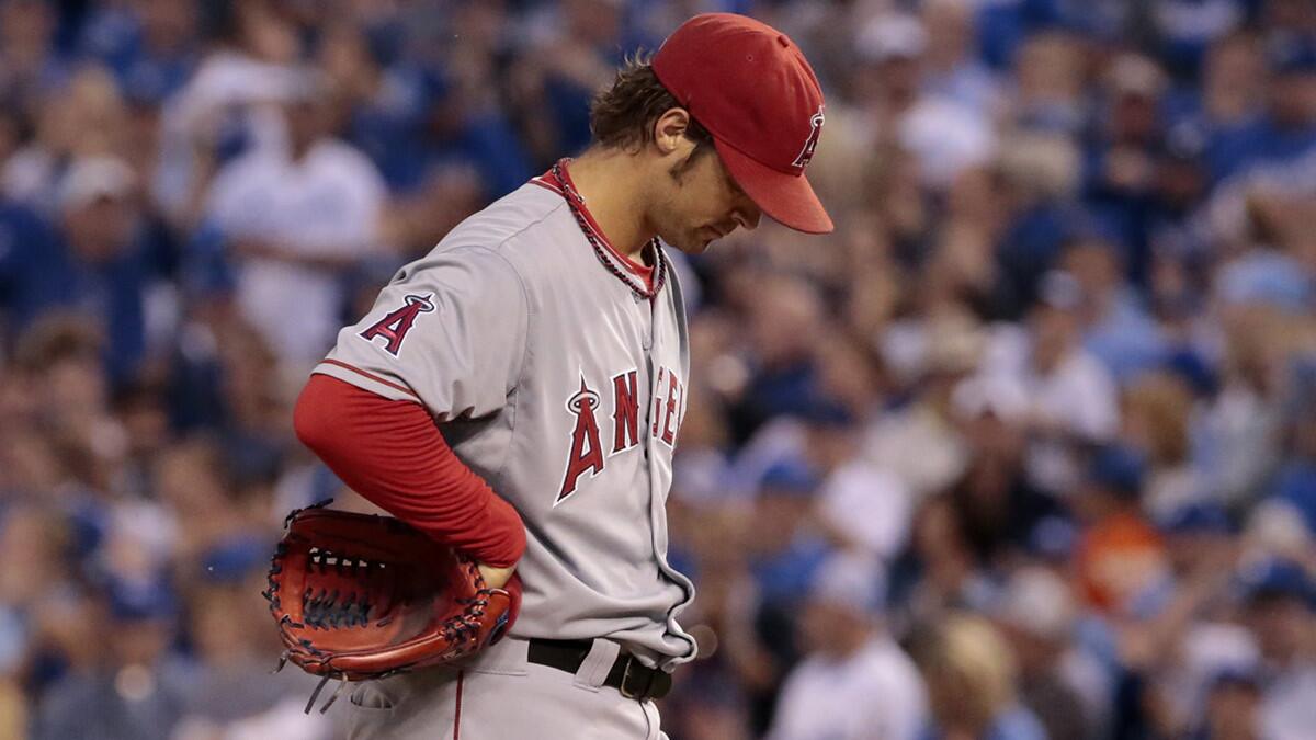 Angels starter C.J. Wilson looks down after giving up a three-run triple in the first inning of an 8-3 loss to the Kansas City Royals in Game 3 of the ALDS on Sunday.