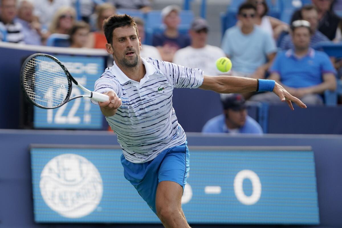 Novak Djokovic hits a forehand during his match against Daniil Medvedev.