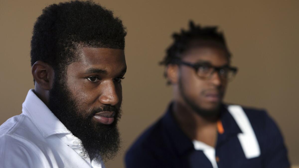 Rashon Nelson, left, and Donte Robinson sit during an interview with a reporter in Philadelphia after their arrest at a local Starbucks.