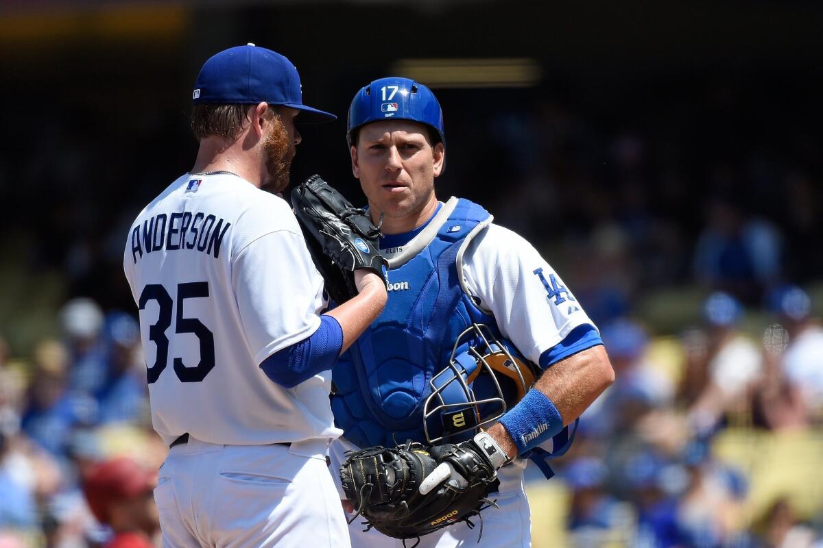 Dodgers catcher A.J. Ellis, shown May 3 with pitcher Brett Anderson, now serves as a backup to Yasmani Grandal, who was acquired as part of an off-season trade that sent Matt Kemp to the San Diego Padres.