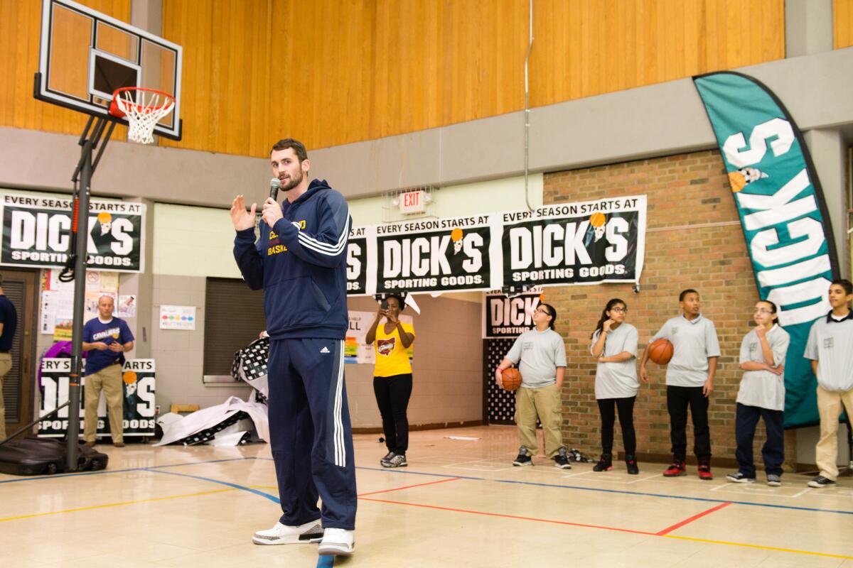 Cleveland Cavaliers player Kevin Love talks to the students from Scranton Elementary School during the Dick's Sporting Goods Foundation Holiday Hoops kick-off event Tuesday. The team's tweet on the event missed the mark.