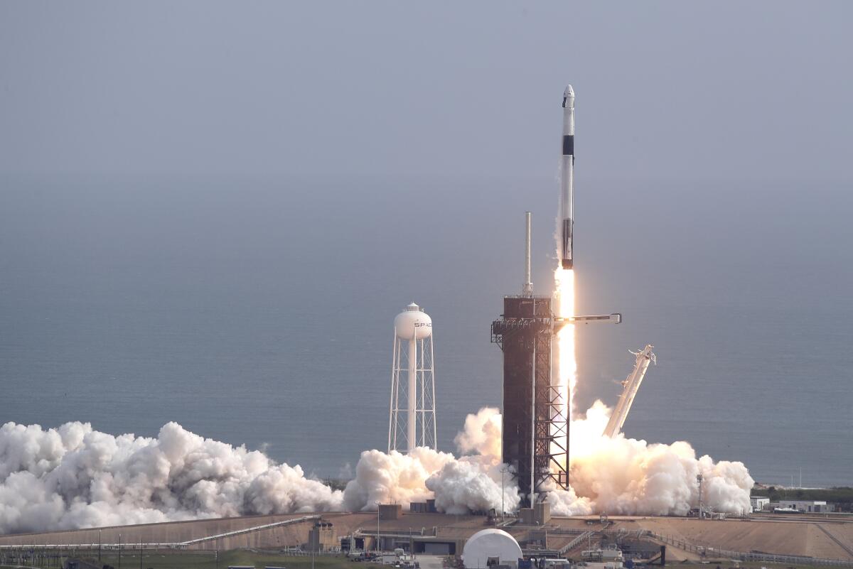 A Falcon 9 SpaceX rocket lifts off from Pad 39A during a test flight of the capsule's emergency escape system in Cape Canaveral, Fla., on Sunday.