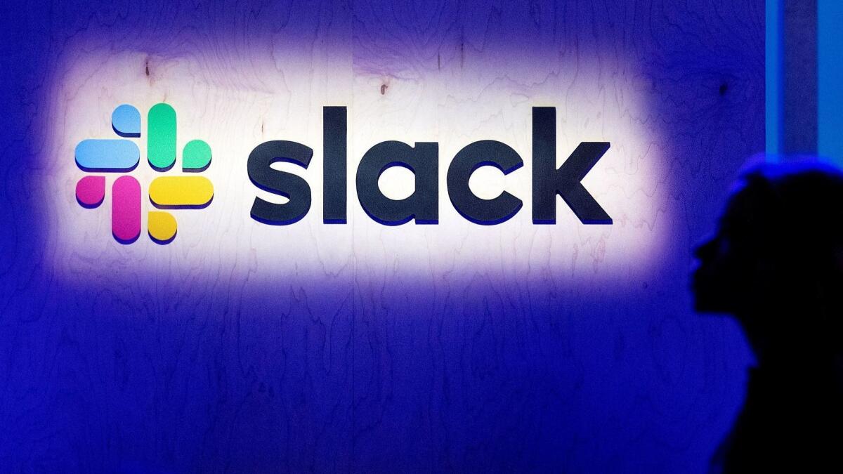 An attendee walks by the company's logo during Slack's Frontiers conference in San Francisco on April 24.