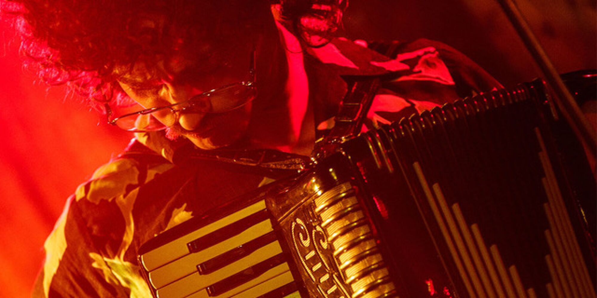 A close-up of a man playing an accordion