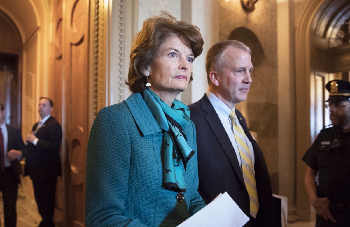 FILE - Sen. Lisa Murkowski, R-Alaska, and Sen. Dan Sullivan, R-Alaska, leave the chamber after a vote on Capitol Hill in Washington, early Wednesday, May 10, 2017. Jay Allen Johnson, 65, who faced charges of sending a series of profanity-laced voice messages to the two senators, entered guilty pleas, Monday, Jan. 3, 2022, in federal court in Fairbanks, Alaska, to two counts of threatening to kill a U.S. official. U.S. District Judge Ralph Beistline accepted Johnson's pleas and set sentencing for April 8. (AP Photo/J. Scott Applewhite, File)