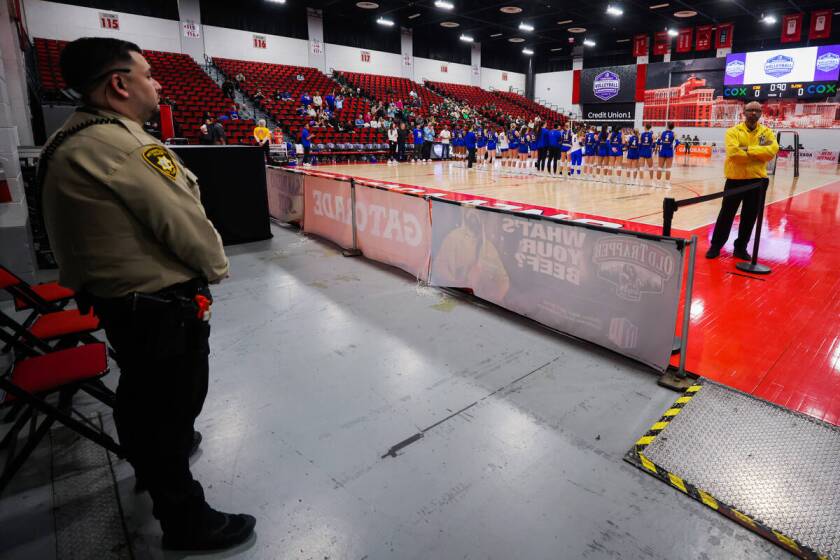 A police officer and security stand near the court as the San Jose State volleyball team is introduced during the Mountain West Championship volleyball game between Colorado State and San Jose State at Cox Pavilion on Nov. 30, 2024, in Las Vegas. (Madeline Carter/Las Vegas Review-Journal)